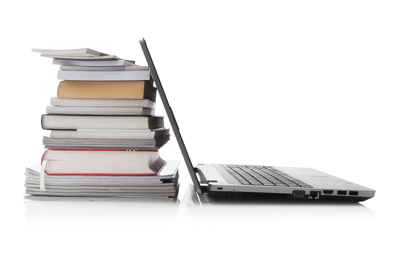 Books and laptop isolated on white background.