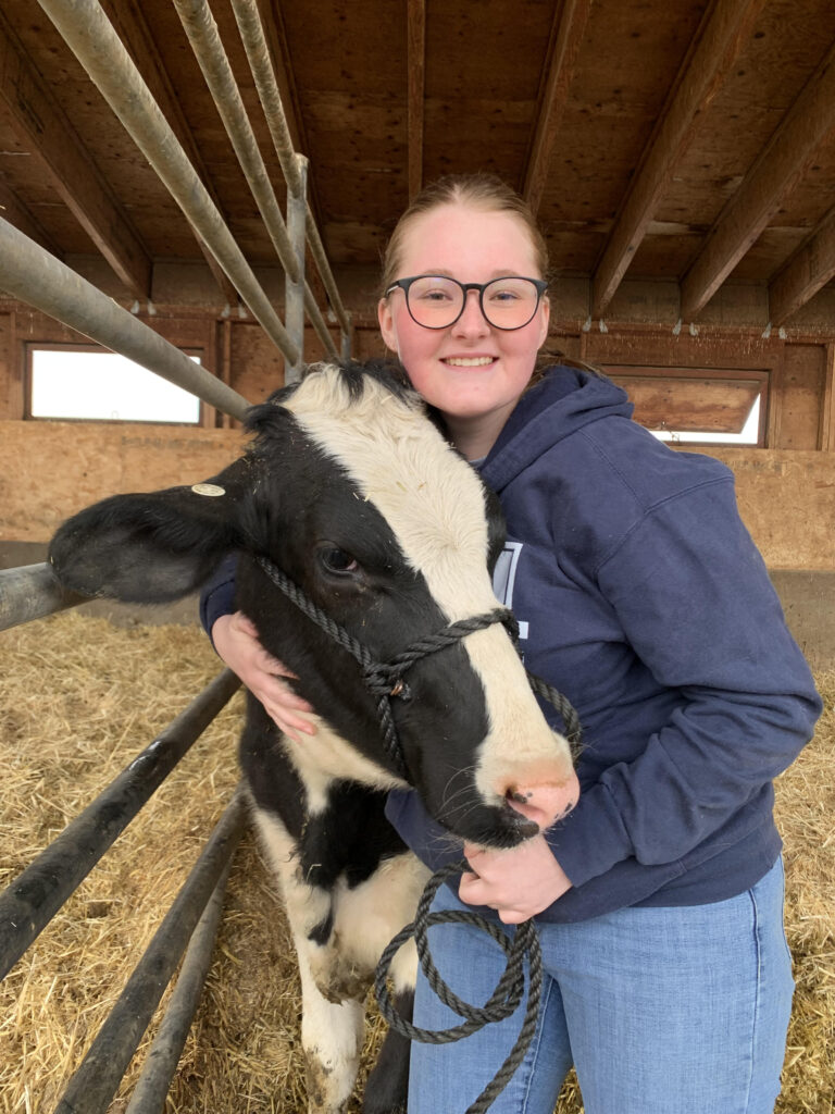 Hallie, an Animal, Dairy and Veterinary Sciences major at Utah State University, is
pictured with her ‘classmate,’ a cow named Mariah. Photo courtesy Hallie D.