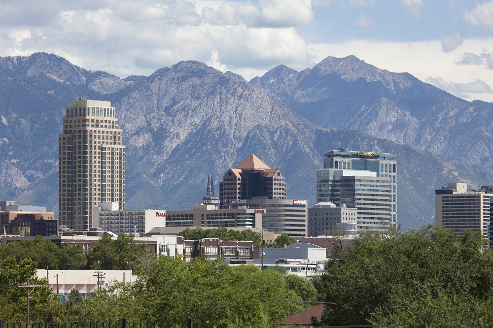 With the Wasatch Mountains in the background, clouds roll past downtown skyscrapers of Salt Lake City in Utah.